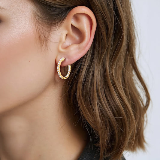 Angled close-up of a model wearing 14K Yellow Gold U-Prong Lab-Grown Diamond Hoop Earrings with lab-grown diamonds